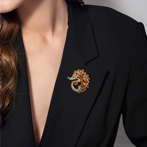 Creative hedgehog brooch with sparkling amber crystals on a black blazer lapel