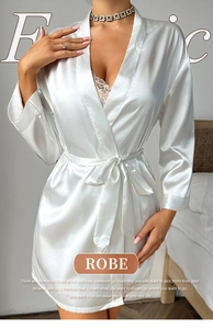 Detail of elegant white silk robe featuring soft satin texture and delicate lace trim
