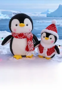 Close-up of penguin plush toy wearing a festive red scarf and star vest on snow