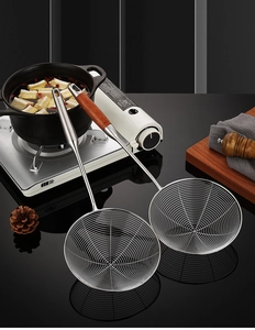 Close-up of stainless steel wire mesh skimmer spoons with ergonomic wooden handles