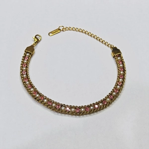 Detailed view of gold stainless steel bracelet with pink crystals and white faux pearls