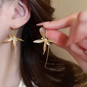 Elegant matte gold iris flower drop earrings with curved hooks for a vintage floral look