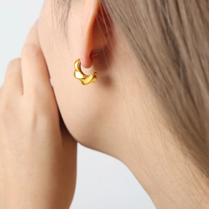 Elegant 18K gold plated titanium steel earrings with irregular twisted wave design on model