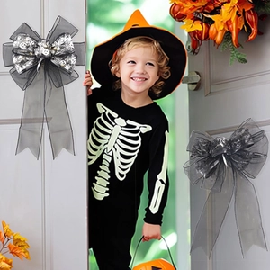 Halloween black and grey LED skull print bows hanging on a white door frame for party decor