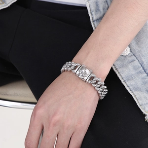 Close-up of silver Cuban link bracelet with skull buckle and pavé set cubic zirconia