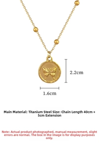 Macro view of gold titanium steel coin necklace featuring an engraved butterfly pendant