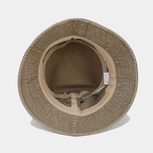 Detail of internal lining and care label on khaki washed cotton bucket hat