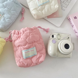 Detailed view of pastel quilted camera pouches with heart stitching and drawstrings