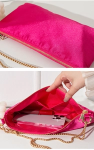 Macro shot showing rose red satin texture and interior capacity for phone and lipstick