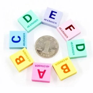 Colorful 4B alphabet erasers in a circular arrangement with coin for size reference