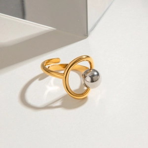 Detailed view of two-tone gold and silver steel beads on an adjustable open ring band