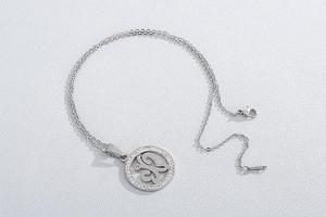 Detail of silver clover pendant with rhinestones and standard lobster clasp closure