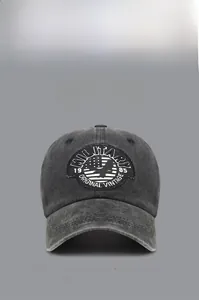 Detail of vintage washed cotton baseball cap with embroidered military eagle patch