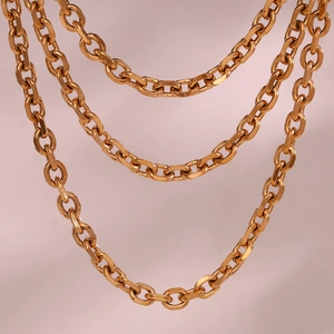 Macro shot of gold-plated stainless steel chain necklace with polished oval links