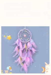 Detailed view of a pink and lavender dreamcatcher with feathers and macaroon beads