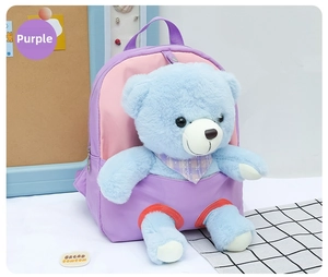 Detail of purple children backpack featuring a cute blue plush bear with a plaid scarf