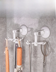 Close-up of white 360-degree rotating 6-claw suction hooks with kitchen utensils