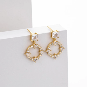 Close-up of gold S925 silver earrings with square zircon and paved circular pendant