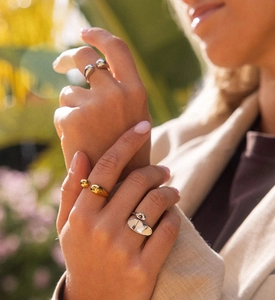 Detail of minimalist S925 sterling silver open rings with golden and silver irregular shapes