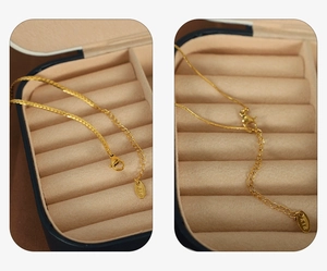Detailed close-up of a double-layered 18K gold snake chain with K18 engraved hallmark