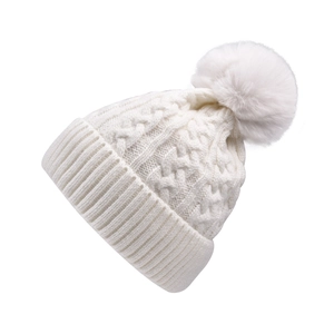 Detailed cable-knit texture and soft pom-pom on off-white winter beanie hat