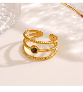 Detail of 18K gold stainless steel triple-layered ring with round tiger eye gemstone inlay