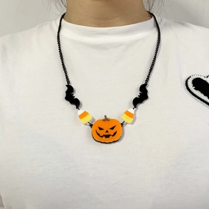Gothic Halloween necklace featuring bat pumpkin pendants and colorful beads on model