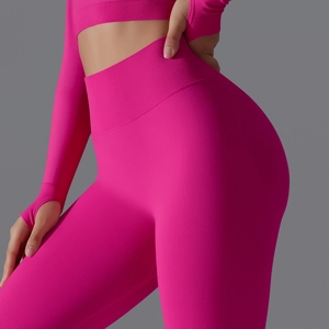 Detail of high-waist seamless compression waistband and pink knit texture on yoga pants