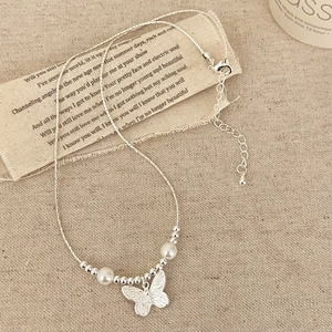 Elegant silver butterfly necklace with pearls and beads on a woven chain for women