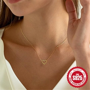 Elegant S925 sterling silver hollow heart necklace for women in gold finish on model