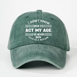 Detail of dark green washed cotton baseball cap with white printed humor slogan text