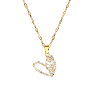 Elegant gold hollow heart pendant necklace with shimmering crystals on white background