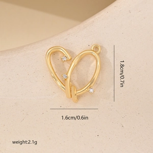Detail view of a gold heart charm with white zircon showing dimensions 1.8cm x 1.6cm