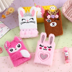 Close-up of cute plush cartoon animal notebooks including bunny and fox with soft embroidery