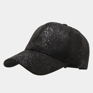 Detailed close-up of a black baseball cap featuring a premium snakeskin embossed texture