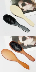 Detail view of boar bristle hair brushes in black, beige, brown, and natural wood finishes
