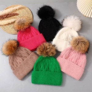 Warm women's Angora rabbit fur beanie with large raccoon fur pom-pom in multiple colors