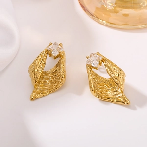 Irregular textured gold earrings with square zircon stone in an elegant minimalist setup