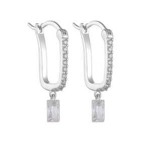 Detailed close-up of U-shaped silver earrings with sparkling rectangular zircon pendants