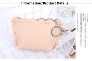 Detail of strawberry coin purse showing scalloped edge and purple leather lining