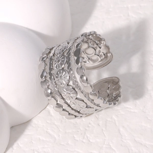 Detailed shot of retro silver hollow wide open ring with sun flower and rope patterns
