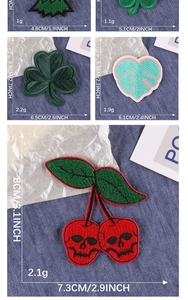 Detail of embroidered cartoon leaf and cherry patches with size measurements on denim