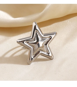 Close-up of a silver pentagram star ring on elegant champagne silk fabric background