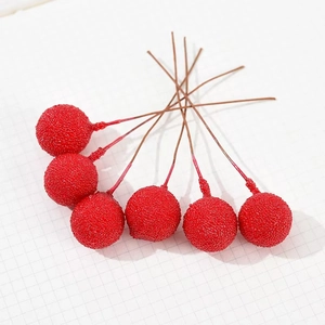 Detail of 6 artificial red foam berries with textured surface on brown stems for decor