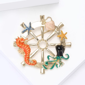 Golden ship wheel brooch with colorful enamel seahorse, starfish and octopus elements