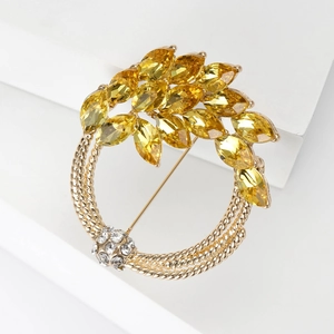 Detailed view of wheat brooch with yellow marquise crystals and woven gold texture