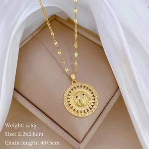 Detail view of gold sun face pendant with sparkling rhinestones on jewelry box