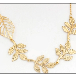 Golden metal leaf pendant necklace with hollow branch design and tassel chains for women