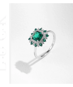 Macro view of S925 sterling silver ring with large emerald cut green stone halo setting