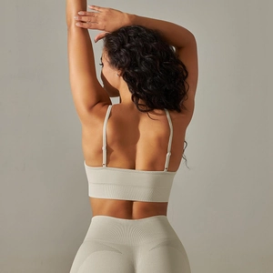 Detail of seamless grey yoga bra with ribbed texture and breathable knit mesh design